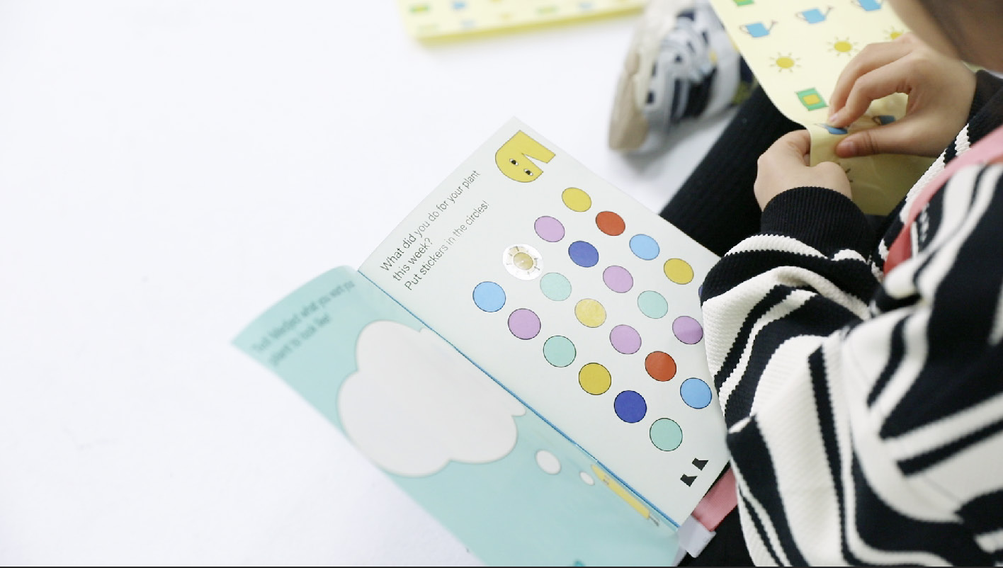 A child using Medjed’s Journey activity materials at a table.