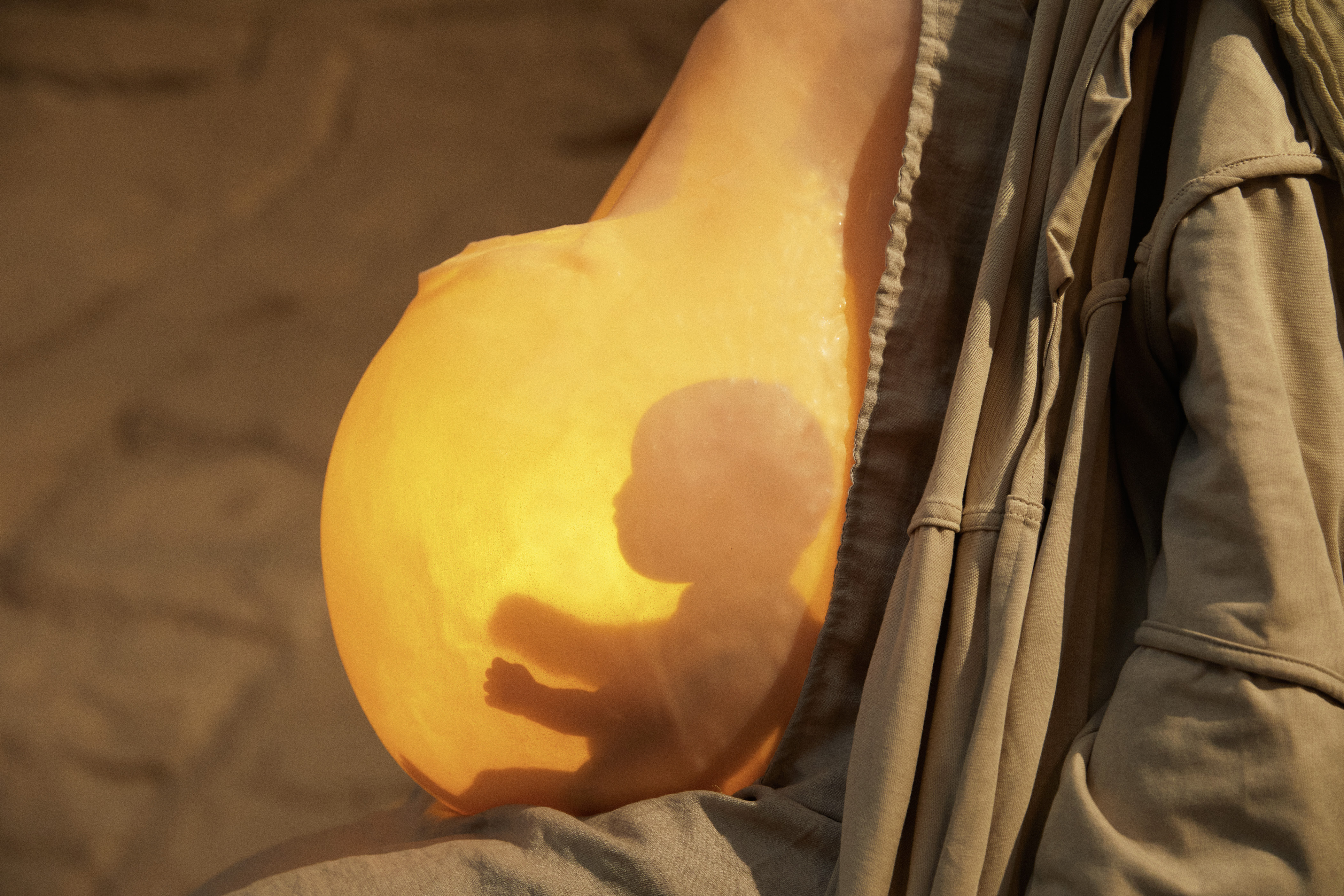 Close-up of a speculative illuminated artificial-womb wearable.