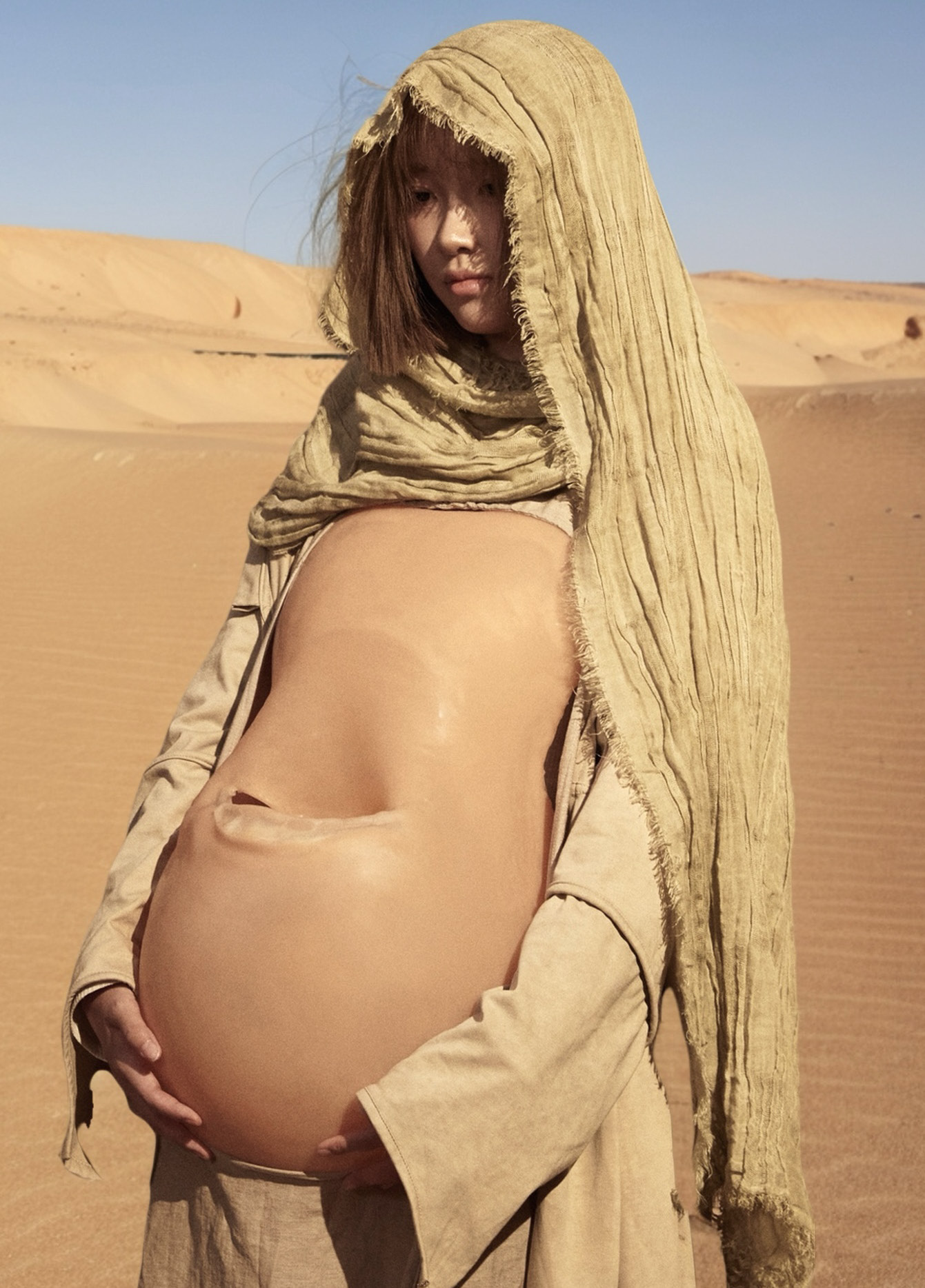 A speculative NEO-Organ Origin wearable photographed in a desert landscape.