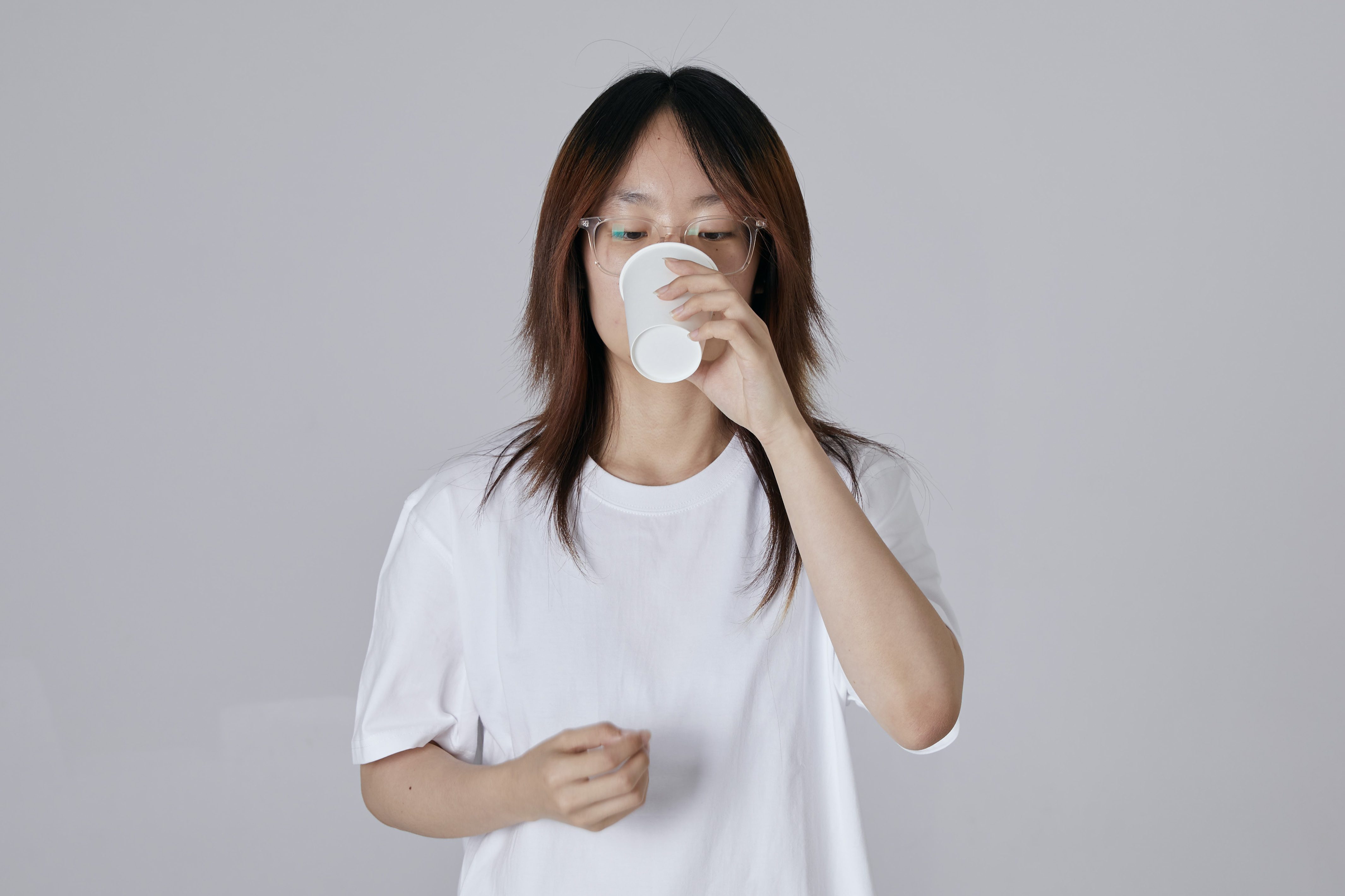 A participant holding a cup during a Virus Experience Hall demonstration.